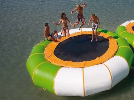 Schwimmendes Wassertrampolin mit grün-weißer Umrandung, ideal für Spaß auf Seen und am Strand, jetzt hochwertig online kaufen.